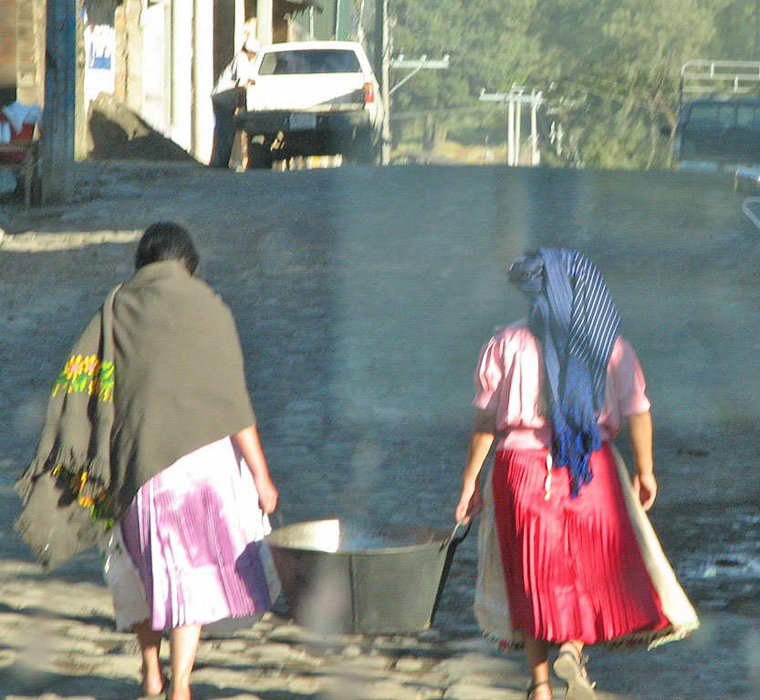 Two women with laundry bucket